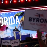 Florida Republican gubernatorial candidate Rep. Byron Donalds stands at a podium in front of a large 