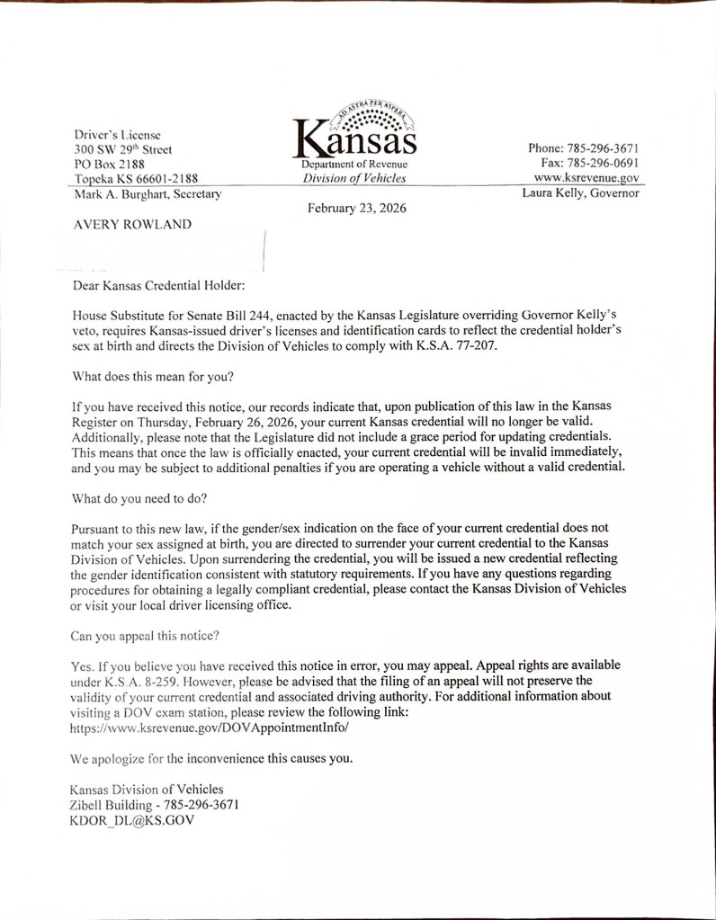 A letter dated February 23, 2026, from the Kansas Department of Revenue's Division of Vehicles, addressed to Avery Rowland. The letter states that under a new state law, driver's licenses and identification cards that do not reflect the holder's sex assigned at birth will become invalid on February 26, 2026. Recipients are instructed to surrender their current credentials and obtain replacements.