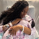 Rep. LaMonica McIver holds her newborn daughter in a hospital bed.