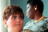 Two women look in opposite directions in closeup.
