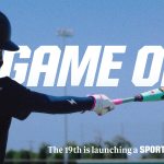 A person holding a bat with overlaying text reading Game On and The 19th is launching a sports desk.